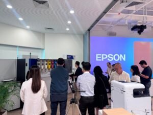 People gather in a modern room with Epson branding